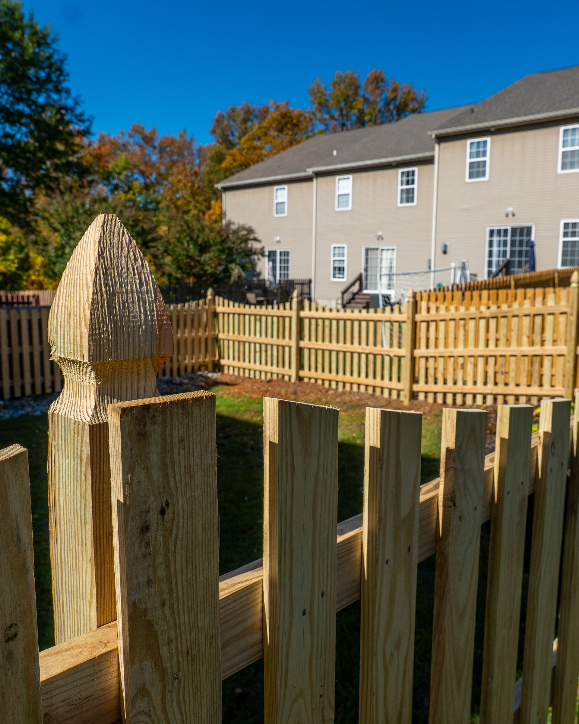 Residential wood fence installation at dusk